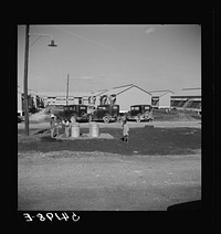 [Untitled photo, possibly related to: Running water and garbage and refuse disposal cans are placed at head of each shelter unit division at Okeechobee migratory labor camp. Belle Glade, Florida]. Sourced from the Library of Congress.