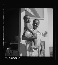 Mother and child at Okeechobee migratory labor camp where they have a nurse and clinic for both prenatal and postnatal care. Belle Glade, Florida. Sourced from the Library of Congress.