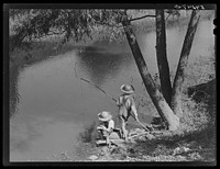 Cajun children fishing in a bayou near the school by Terrebonne Project. Schriever, Louisiana. Sourced from the Library of Congress.