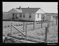 Home with covered cistern for water and fenced garden on Terrebonne Project. Schriever, Louisiana. Sourced from the Library of Congress.