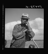 Member of Allen Plantation cooperative association resting while hoeing cotton. Near Natchitoches, Louisiana. Sourced from the Library of Congress.