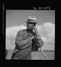 [Untitled photo, possibly related to: Member of Allen Plantation cooperative association resting while hoeing cotton. Near Natchitoches, Louisiana]. Sourced from the Library of Congress.