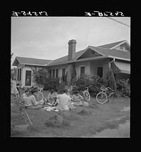 [Untitled photo, possibly related to: Boys in Natchitoches, Louisiana, folding papers before delivering them in the afternoon]. Sourced from the Library of Congress.