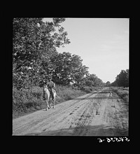 [Untitled photo, possibly related to: Melrose, Natchitoches Parish, Louisiana. Mulatto returning home after buying supplies at country store]. Sourced from the Library of Congress.