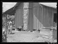 [Untitled photo, possibly related to: Melrose, Natchitoches Parish, Louisiana. Chimney built of mud and sticks on home of mulatto family, a tenant on Balthazar Plantation (see general caption)]. Sourced from the Library of Congress.