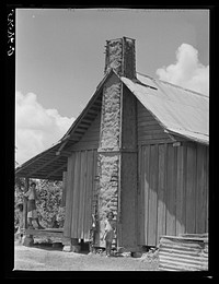 [Untitled photo, possibly related to: Melrose, Natchitoches Parish, Louisiana. Chimney built of mud and sticks on home of mulatto family, a tenant on Balthazar Plantation (see general caption)]. Sourced from the Library of Congress.