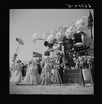 [Untitled photo, possibly related to: Children enjoying the midway after a parade at the Memphis cotton carnival. Memphis, Tennessee]. Sourced from the Library of Congress.