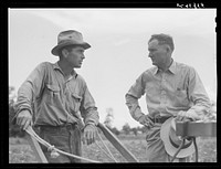 Parish FSA (Farm Security Administration) supervisor Willis R. Roberts talking and discussing farm problems with brother-in-law of Pleas W. Rodden, rural rehabilitation borrower, who had been cultivating his cotton. West Carroll Parish, Louisiana. Sourced from the Library of Congress.