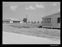 [Untitled photo, possibly related to: Showers for both babies and older children and for parents and complete laundry facilities are provided in the utility building for members of the Osecola migratory labor camp. Belle Glade, Florida]. Sourced from the Library of Congress.