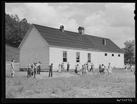 Two-room school house near Morehead, Kentucky. In these mountain areas the school term begins in June and goes through January, because in the late winter and spring months the weather is so severe and roads so bad and childrens' clothing is too inadequate. Sourced from the Library of Congress.