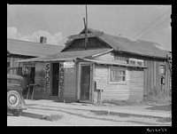 Shoe and harness repair shop and beauty shop. Shelby, Mississippi. Sourced from the Library of Congress.