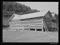 Modern log house under construction near Morehead, Kentucky. Sourced from the Library of Congress.