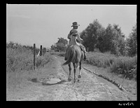 [Untitled photo, possibly related to: Melrose, Natchitoches Parish, Louisiana. Mulatto returning home after buying supplies at country store]. Sourced from the Library of Congress.