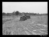 [Untitled photo, possibly related to: Harvesting soybean seed on the Roger's farm with co-op combine purchased by Emery M. Hooper through a FSA (Farm Security Administration) co-op community service loan. Corbett Ridge section, Caswell County, North Carolina]. Sourced from the Library of Congress.