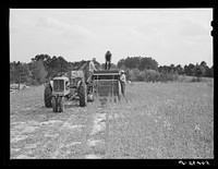 [Untitled photo, possibly related to: Harvesting soybean seed on the Roger's farm with co-op combine purchased by Emery M. Hooper through a FSA (Farm Security Administration) co-op community service loan. Corbett Ridge section, Caswell County, North Carolina]. Sourced from the Library of Congress.