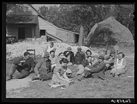 [Untitled photo, possibly related to: Resting after dinner following a corn shucking on Hoopers' farm in Corbett Ridge section. Caswell County, North Carolina]. Sourced from the Library of Congress.