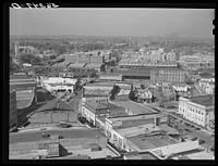 [Untitled photo, possibly related to: Five points, center of city, with Chesterfield cigarette factories in background. Durham, North Carolina]. Sourced from the Library of Congress.