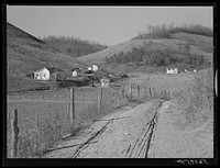 Homes of Noah Garland's son and a neighboring FSA (Farm Security Administration) borrower along the creek. Near Barbourville, Knox County, Kentucky. Southern Appalachian Project. Sourced from the Library of Congress.