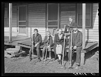 Dutton ("Dut") Calleb and his family with their homemade hoes on the porch of their home. Southern Appalachian Project near Barbourville, Knox County, Kentucky. Sourced from the Library of Congress.