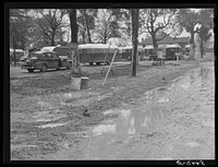 Jones Trailer Camp where army men and construction workers and their families live. They pay two dollars and fifty cents weekly for space only. One said "It's nothing but a mud hole, only running water, you can't find a decent place to live in Columbus, and nobody will allow children in their homes--it's a shame. We was all children once. Most folks got children.". Sourced from the Library of Congress.