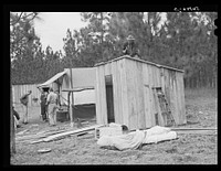 J.R. Jones from Monroe, Louisiana, building new shack to live in temporarily while works on construction job at Camp Livingstone near Fort Beauregard. Sourced from the Library of Congress.