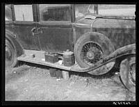 Close-up of car from Mississippi used for sleeping as well as shelter and traveling. Evidences of cooking outside are beside it. On highway near Camp Livingston. Alexandria, Louisiana. Sourced from the Library of Congress.