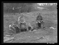 [Untitled photo, possibly related to: Two construction workers who sleep in car, cooking outdoors. One is from Memphis, Tennessee, and worked formerly on the construction of Dupont plant at Millington, Tennessee. The other is from Decatur, Mississippi, and worked previously at the Camp Shelby job, Hattiesburg, Mississippi. He said: "We live like kings out here. I never did carpenter before I heard you could get paid so much for it; then it didn't take me long to be one." They are both working on the Camp Livingston job near Alexandria, Louisiana]. Sourced from the Library of Congress.