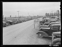 [Untitled photo, possibly related to: Construction workers' cars parked along highway by Camp Claiborne near Alexandria, Louisiana]. Sourced from the Library of Congress.