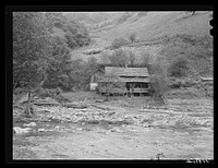 Farm house along creek bed in recently flooded area northwest of Asheville, North Carolina. Sourced from the Library of Congress.