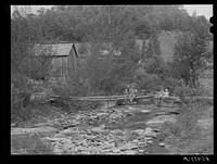 Farmhouses along creek bed in recently flooded area northwest of Asheville, North Carolina. Sourced from the Library of Congress.