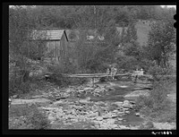 [Untitled photo, possibly related to: Farmhouses along creek bed in recently flooded area northwest of Asheville, North Carolina]. Sourced from the Library of Congress.