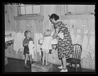 Children of agricultural and packing house workers washing up before getting a hot lunch in twenty-four hour a day nursery at Osceola migratory labor camp. Belle Glade, Florida by Marion Post Wolcott