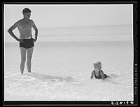 [Untitled photo, possibly related to: Guest of Sarasota trailer park, Sarasota, Florida, with his family, picnicking at the beach]. Sourced from the Library of Congress.