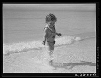 Daughters of guests at Sarasota trailer park, Sarasota, Florida, playing in water before picnic lunch at beach. Sourced from the Library of Congress.