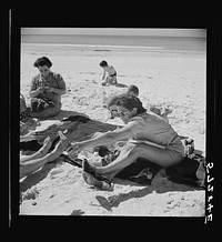 [Untitled photo, possibly related to: Guest of Sarasota trailer park, Sarasota, Florida, at the beach with her family]. Sourced from the Library of Congress.