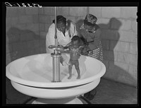 Sanitary facilities are provided in migratory labor camp. Belle Glade, Florida. Sourced from the Library of Congress.