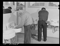 [Untitled photo, possibly related to: Workers from electric boat company plant in washroom of new dormitories for defense workers. Groton, Connecticut. Constructed and managed by FSA (Farm Security Administration)]. Sourced from the Library of Congress.