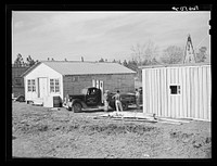 [Untitled photo, possibly related to: Cars of construction workers at Camp Claiborne, Alexandria, Louisiana. New buildings on highway at Camp Claiborne. Cabins, sleeping quarters, etc., being built by private interest for construction workers. Louisiana]. Sourced from the Library of Congress.