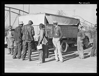  construction workers waiting by truck to go to work on Camp Livingston jobs. Alexandria, Louisiana. Sourced from the Library of Congress.
