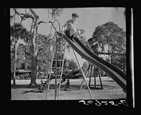 Playing in the playground in Sarasota trailer park. Sarasota, Florida. Sourced from the Library of Congress.