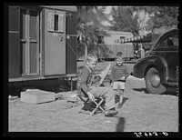 [Untitled photo, possibly related to: Children playing outside their trailer homes at Sarasota trailer park. Sarasota, Florida]. Sourced from the Library of Congress.