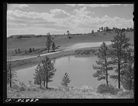 Reservoir for range cattle just finished on Lyman Brewster's lease. Near Lame Deer, Montana. Sourced from the Library of Congress.