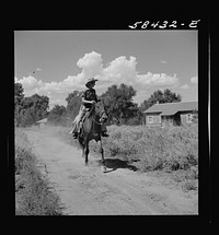 Dude returning from a morning ride. Quarter Circle U Ranch, Birney, Montana. Sourced from the Library of Congress.