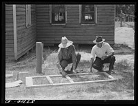 Fastening the stock with corrugated staples. Screen door construction. Charles County, La Plata, Maryland. Sourced from the Library of Congress.