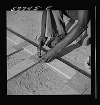 Nails are driven through the metal into wood. Demonstration of home screen door construction. Saint Mary's County, Ridge, Maryland. Sourced from the Library of Congress.