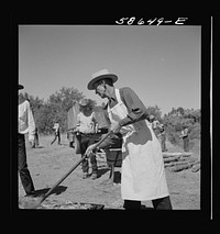 The chef barbecuing beef at the stockmen's picnic and barbecue. Spear's Siding, Wyola, Montana. Sourced from the Library of Congress.