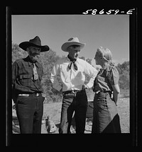 [Untitled photo, possibly related to: Spear's Siding, Wyola, Montana. Lyman Brewster of Quarter Circle U Ranch with Sally Rand and her father, Turk Greenough, at a stockmen's picnic and barbecue]. Sourced from the Library of Congress.