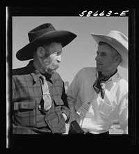 Lyman Brewster of Quarter Circle U Ranch with Turk Greenough's father (Sally Rand's father-in-law) at a stockmen's picnic and barbecue. Spear's Siding, Wyola, Montana. Sourced from the Library of Congress.