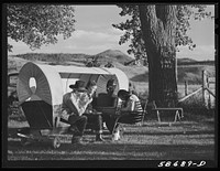 Quarter Circle U, Brewster-Arnold Ranch. Birney, Montana. Dudes in a covered wagon garden seat.. Sourced from the Library of Congress.