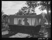[Untitled photo, possibly related to: Dudes in a covered wagon garden seat at Quarter Circle U, Brewster-Arnold Ranch Company. Birney, Montana]. Sourced from the Library of Congress.